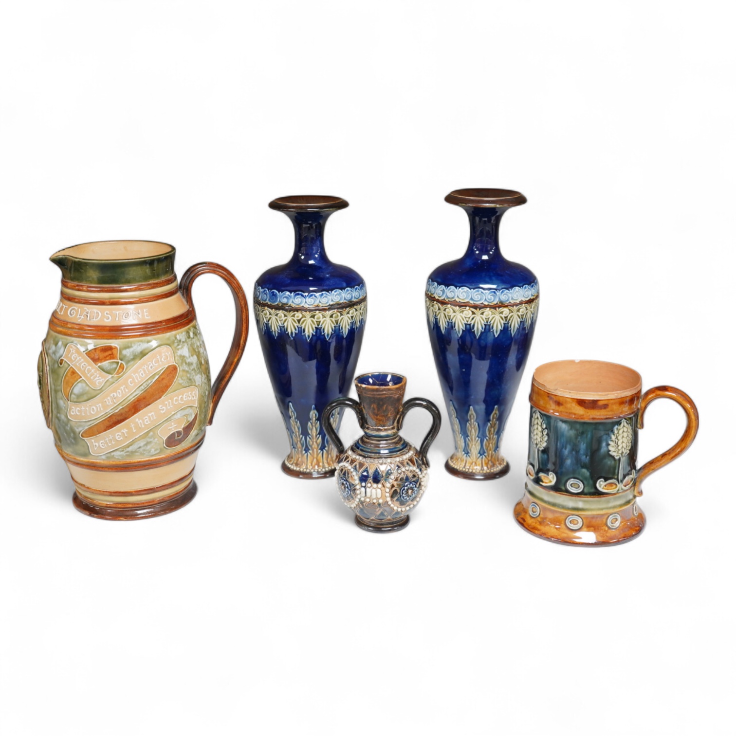 A Doulton Lambeth stoneware commemorative pitcher of William Ewart Gladstone 23cm high, together with a pair of vases two handled vase and a mug, (5).